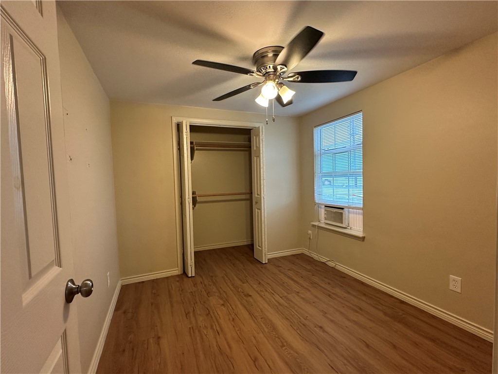 10837 Leopard Street, Unit A Corpus Christi, TX 78410 - Photo 5 of 7 wooden floor in an empty room with a window