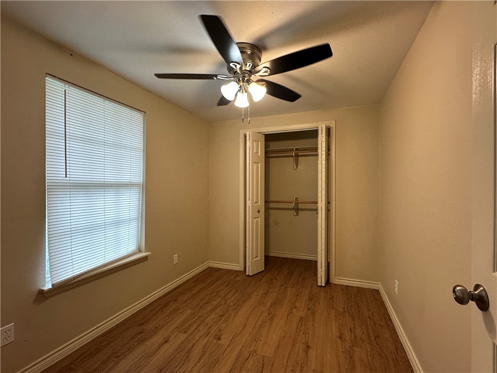 10837 Leopard Street, Unit A Corpus Christi, TX 78410 - Photo 6 of 7 wooden floor in an empty room with a window