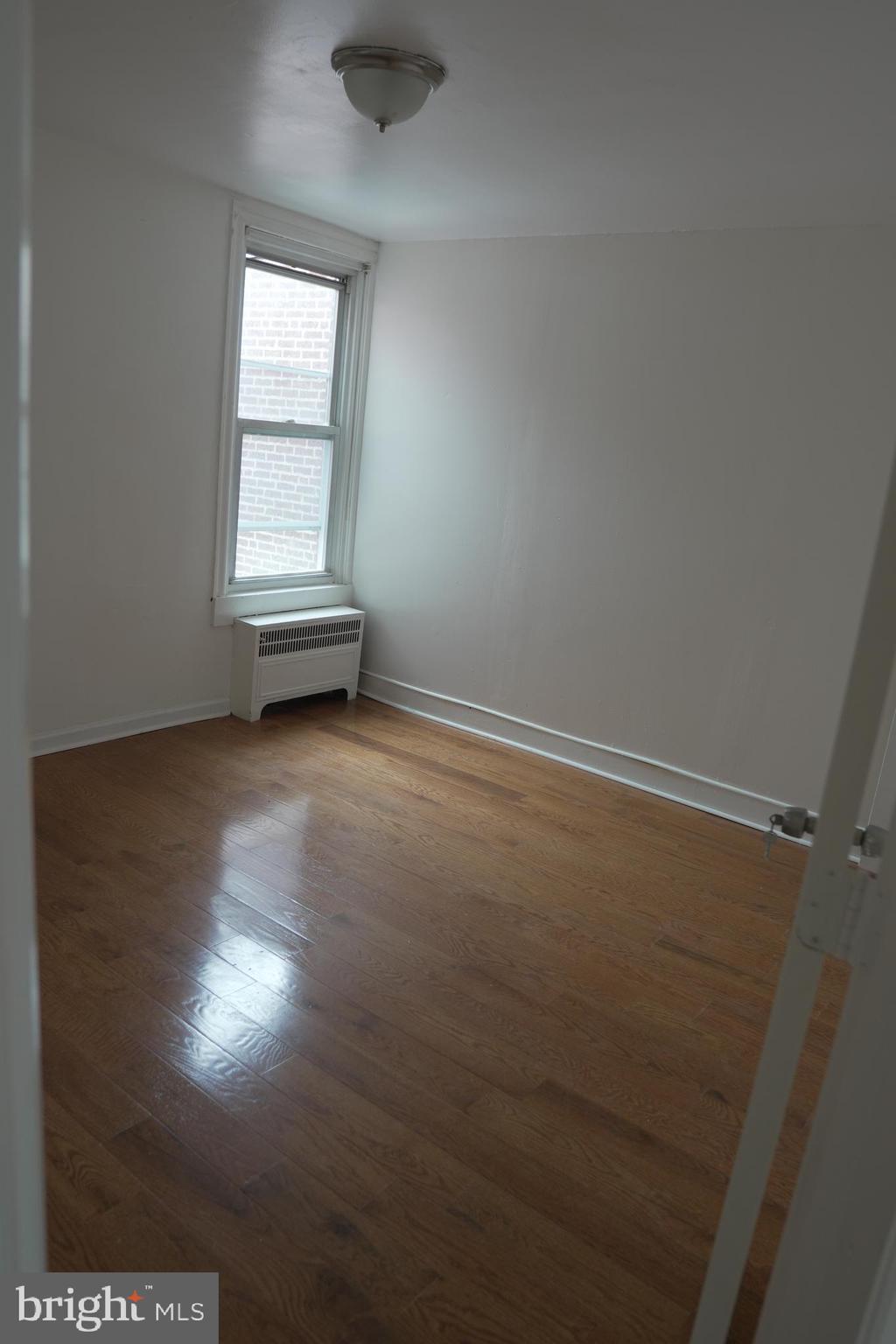 1980 Penfield Street Philadelphia, PA 19138 - Photo 7 of 14 an empty room with wooden floor and windows