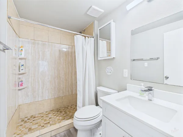 a bathroom with a sink toilet and shower