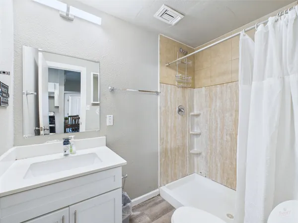 a bathroom with a sink toilet and shower