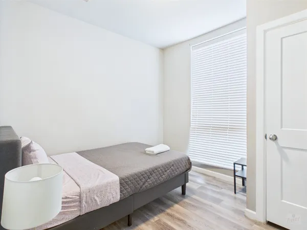 a bedroom with a bed and a chair