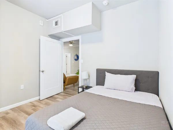 a bedroom with a bed and a chair