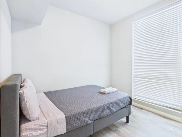 a bedroom with a bed and a window