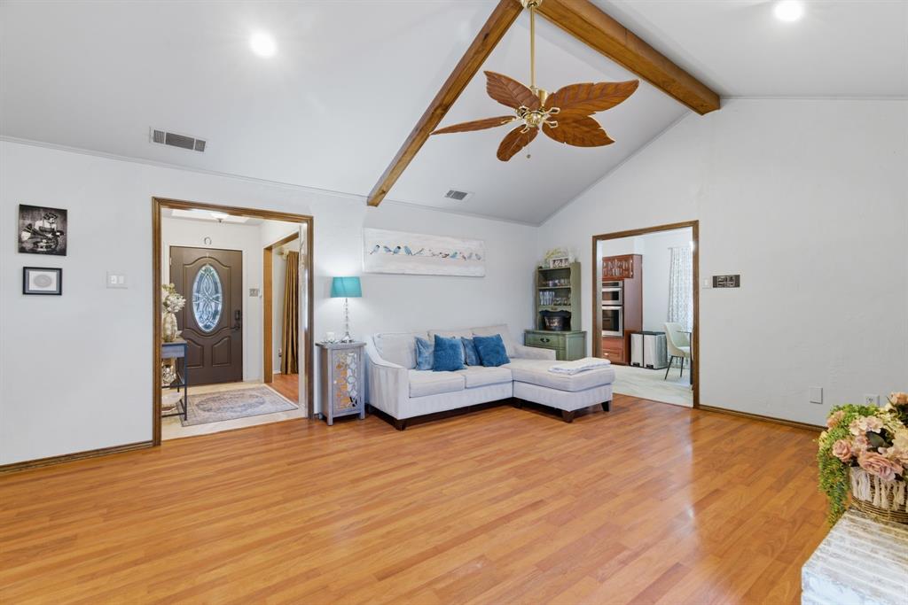 2307 Castle Rock Road Carrollton, TX 75007 - Photo 8 of 34 Living area featuring hardwood flooring, a vaulted ceiling with exposed beams, and a ceiling fan