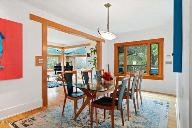 a kitchen with stainless steel appliances granite countertop a refrigerator a sink dishwasher a stove and white countertops with wooden floor