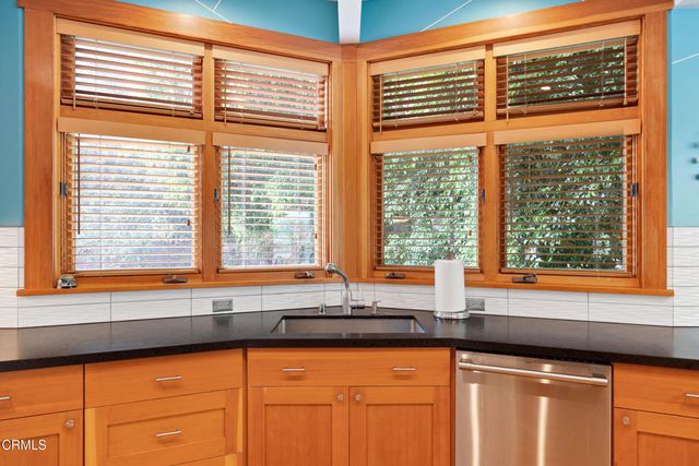 a kitchen with stainless steel appliances granite countertop a sink a stove and a refrigerator