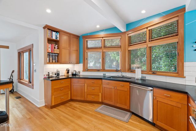 a kitchen with stainless steel appliances granite countertop a sink and cabinets