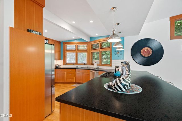 a living room with furniture a floor to ceiling window and wooden floor