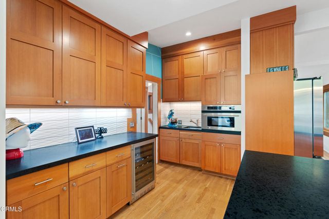 a bedroom with furniture and a large window