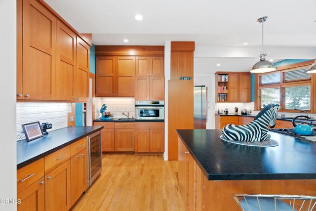 a dining room with furniture and a large window