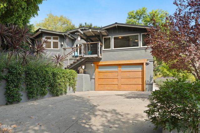 a living room with furniture fireplace and a large window