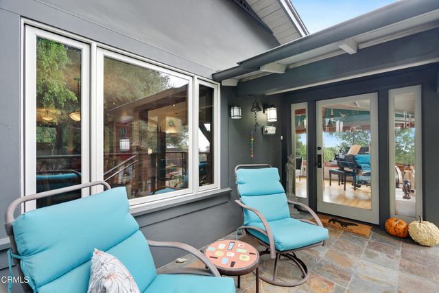 a living room with patio furniture and a fireplace