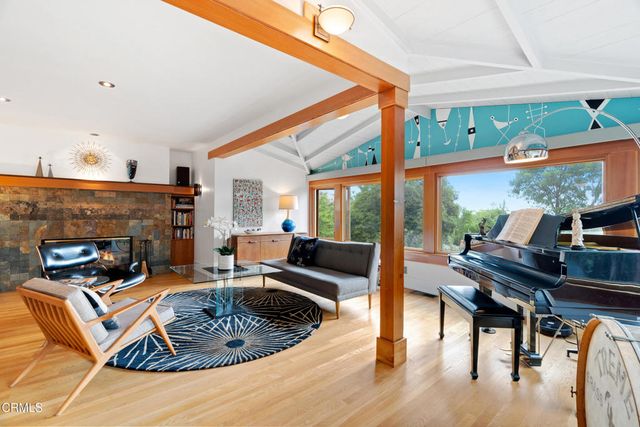 a living room with patio furniture and a potted plant