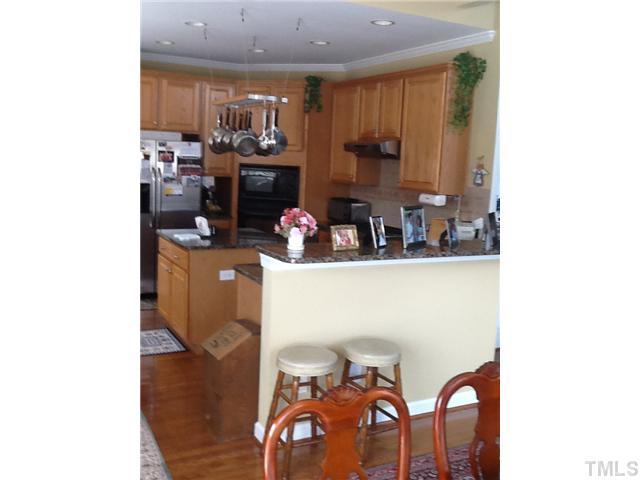 1609 Stannard Trail Raleigh, NC 27612 - Photo 4 of 25 a kitchen with a sink cabinets and appliances