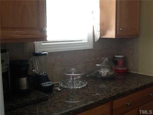 1609 Stannard Trail Raleigh, NC 27612 - Photo 8 of 25 a kitchen with a sink and cabinets