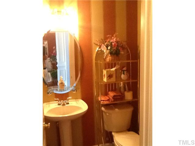 1609 Stannard Trail Raleigh, NC 27612 - Photo 9 of 25 a bathroom with a toilet a sink and mirror