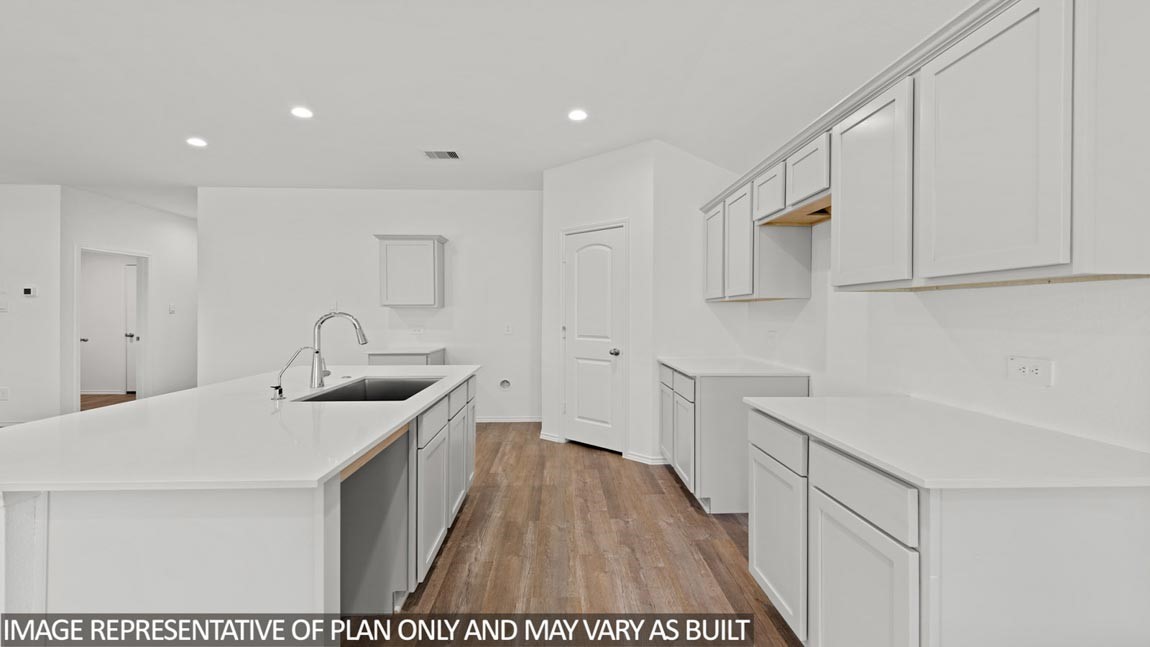 23555 Skyward Lane Splendora, TX 77372 - Photo 2 of 14 a kitchen with a sink and cabinets