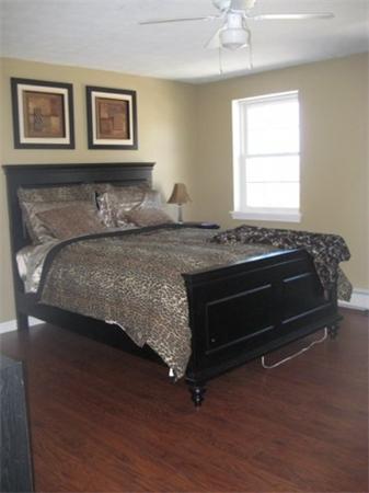 4 Fern Street Templeton, MA 01436 - Photo 23 of 30 a bedroom with a bed and a chandelier