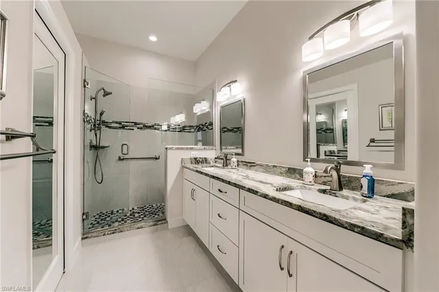 a bathroom with a granite countertop sink mirror and double