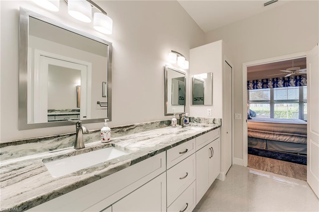 9049 Spring Run Boulevard Estero, FL 34135 - Photo 20 of 36 a bathroom with a sink and a mirror