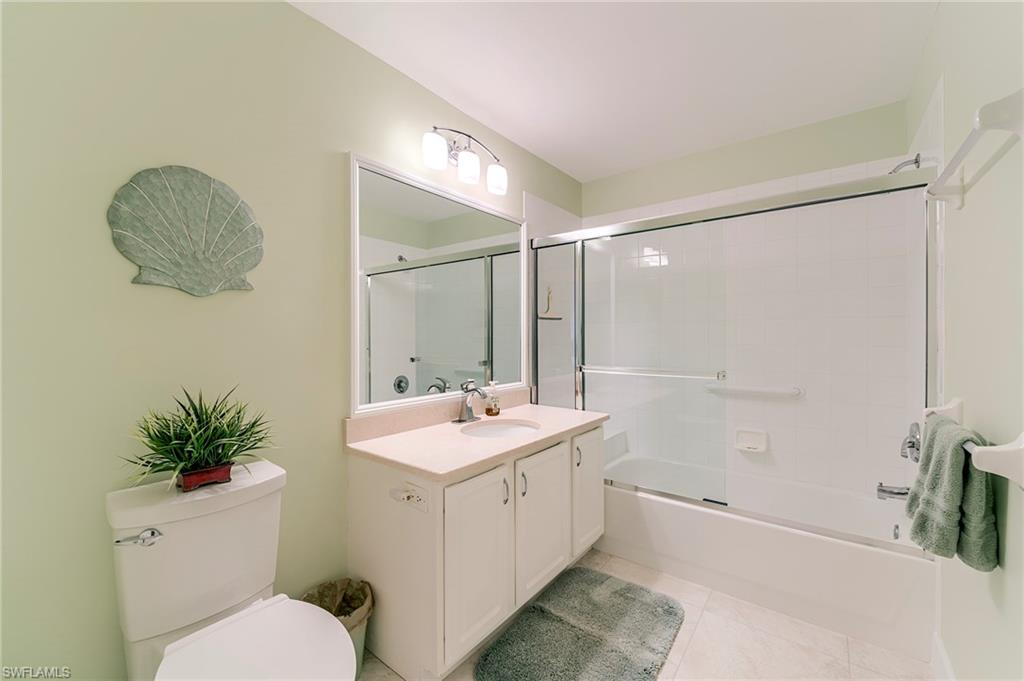 9049 Spring Run Boulevard Estero, FL 34135 - Photo 22 of 36 a bathroom with a sink a toilet and shower