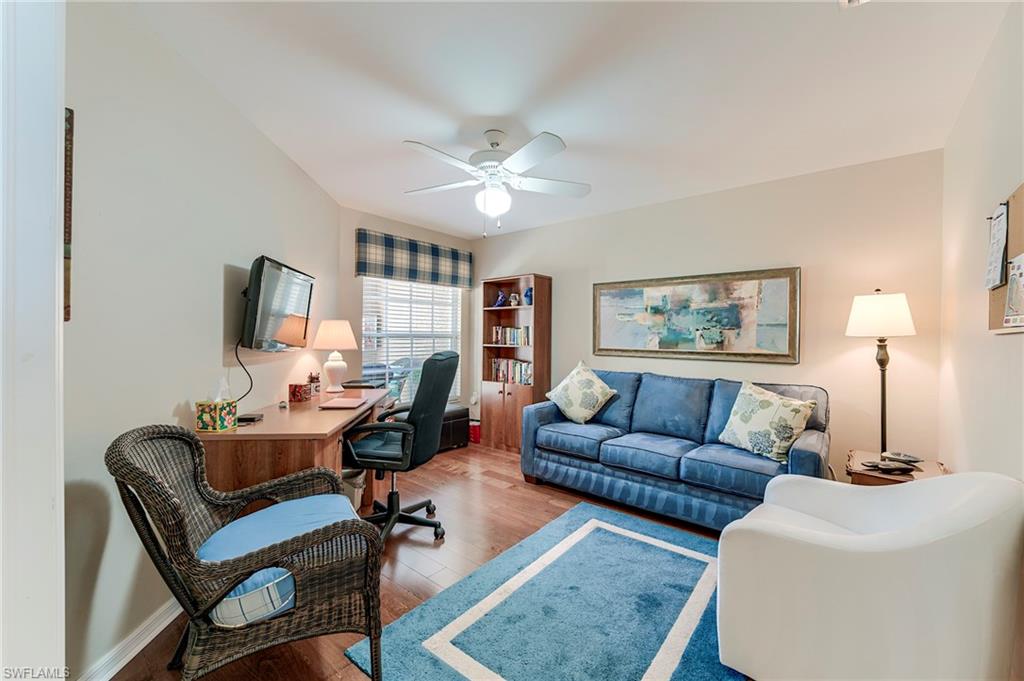 9049 Spring Run Boulevard Estero, FL 34135 - Photo 23 of 36 a living room with furniture a flat screen tv and a window