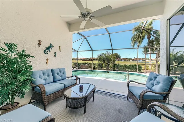 a living room with furniture and a floor to ceiling window
