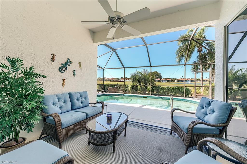 9049 Spring Run Boulevard Estero, FL 34135 - Photo 25 of 36 a living room with furniture and a floor to ceiling window