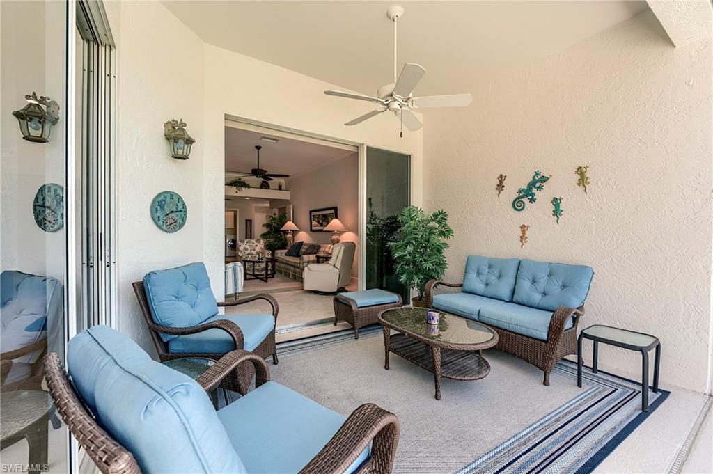 9049 Spring Run Boulevard Estero, FL 34135 - Photo 27 of 36 a living room with furniture and a rug