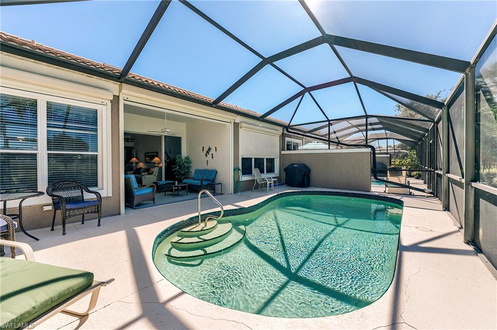 9049 Spring Run Boulevard Estero, FL 34135 - Photo 31 of 36 a view of a swimming pool with a patio