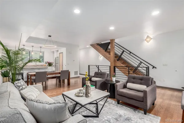 a living room with furniture and wooden floor
