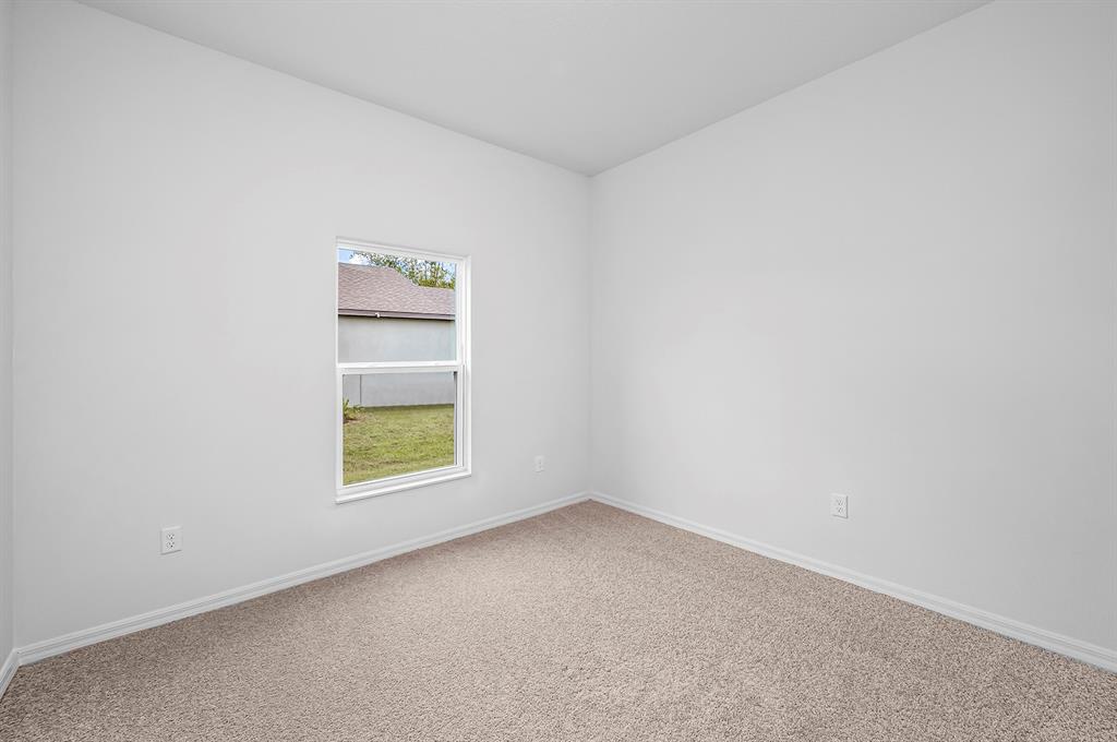 7886 99th Court Vero Beach, FL 32967 - Photo 16 of 18 an empty room with a window