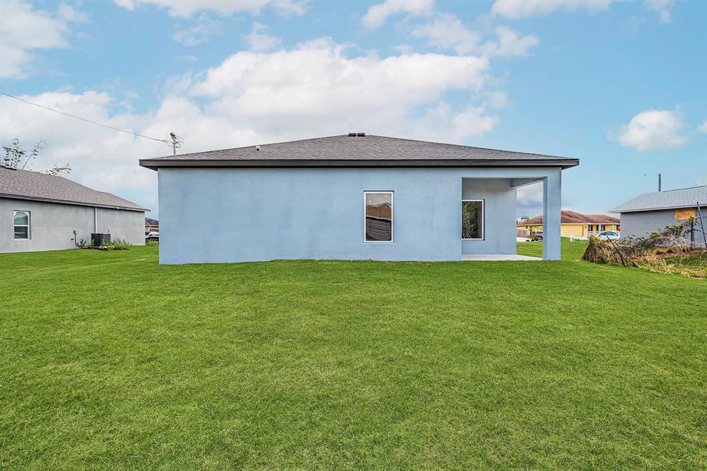 7886 99th Court Vero Beach, FL 32967 - Photo 3 of 18 a house view with a garden space