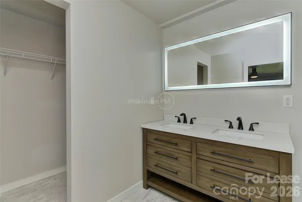 a bathroom with a shower sink and mirror