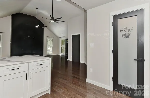 a kitchen with a refrigerator and chandelier