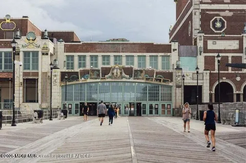 a view of roof with wooden floor and a building in the background