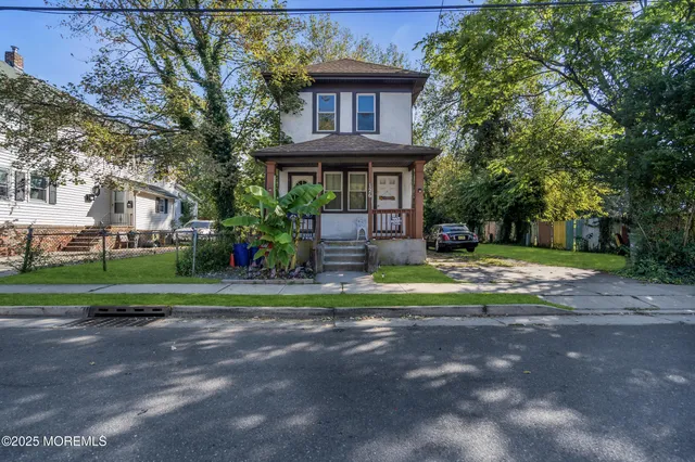 a front view of a house with garden and porch