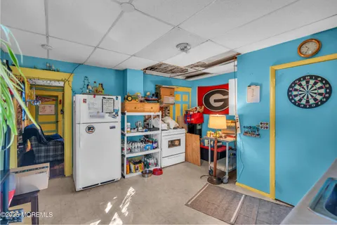 a bedroom with two beds and a painting on the wall