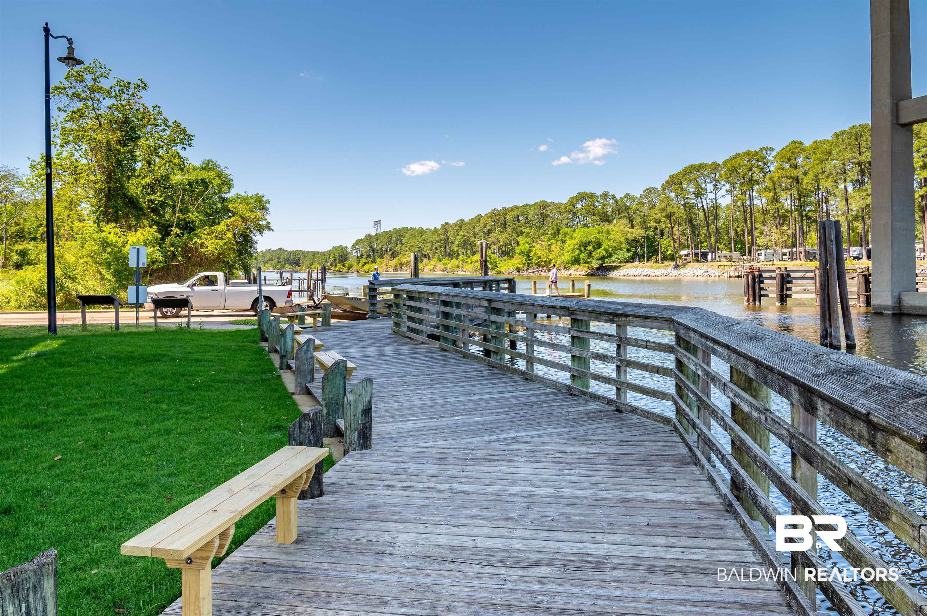 657 Island Way Gulf Shores, AL 36542 - Photo 54 of 59 View of dock with a yard and a water view