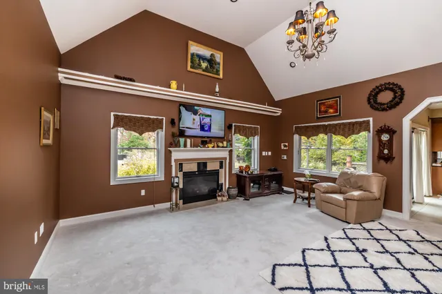 a kitchen with granite countertop a refrigerator and a stove top oven