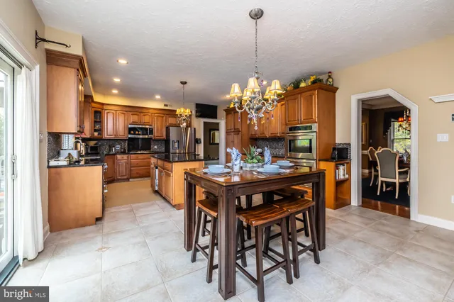 a kitchen with stainless steel appliances granite countertop a sink and cabinets