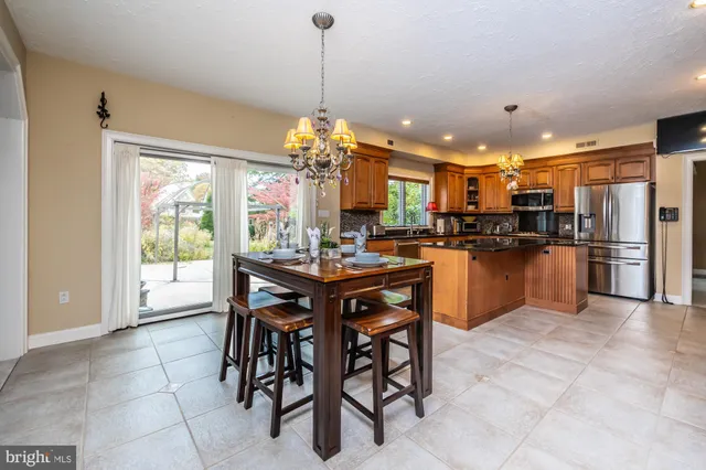 a kitchen with stainless steel appliances granite countertop a stove and a refrigerator