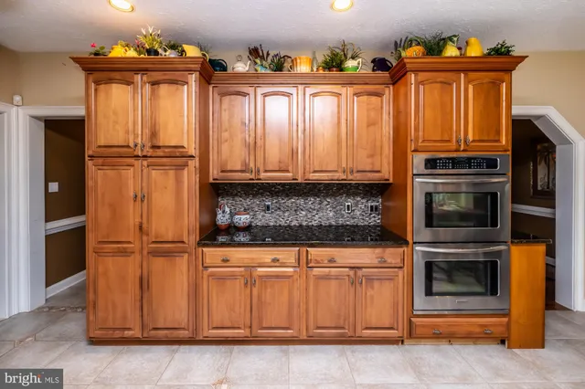 a living room with furniture a rug and a chandelier