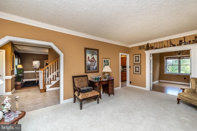 a dining room with furniture a chandelier and wooden floor