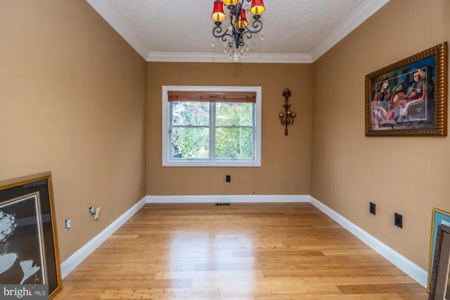 a living room with furniture a fireplace and a large window