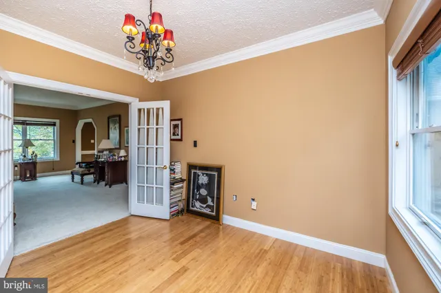 a kitchen with stainless steel appliances kitchen island granite countertop a table chairs and a refrigerator
