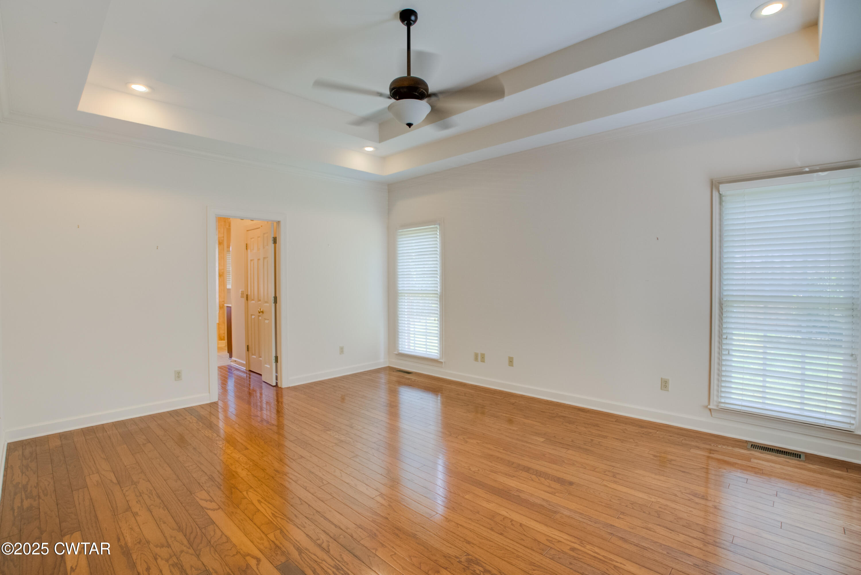 7 Sutton Place Jackson, TN 38305 - Photo 16 of 25 a view of an empty room with wooden floor and a window