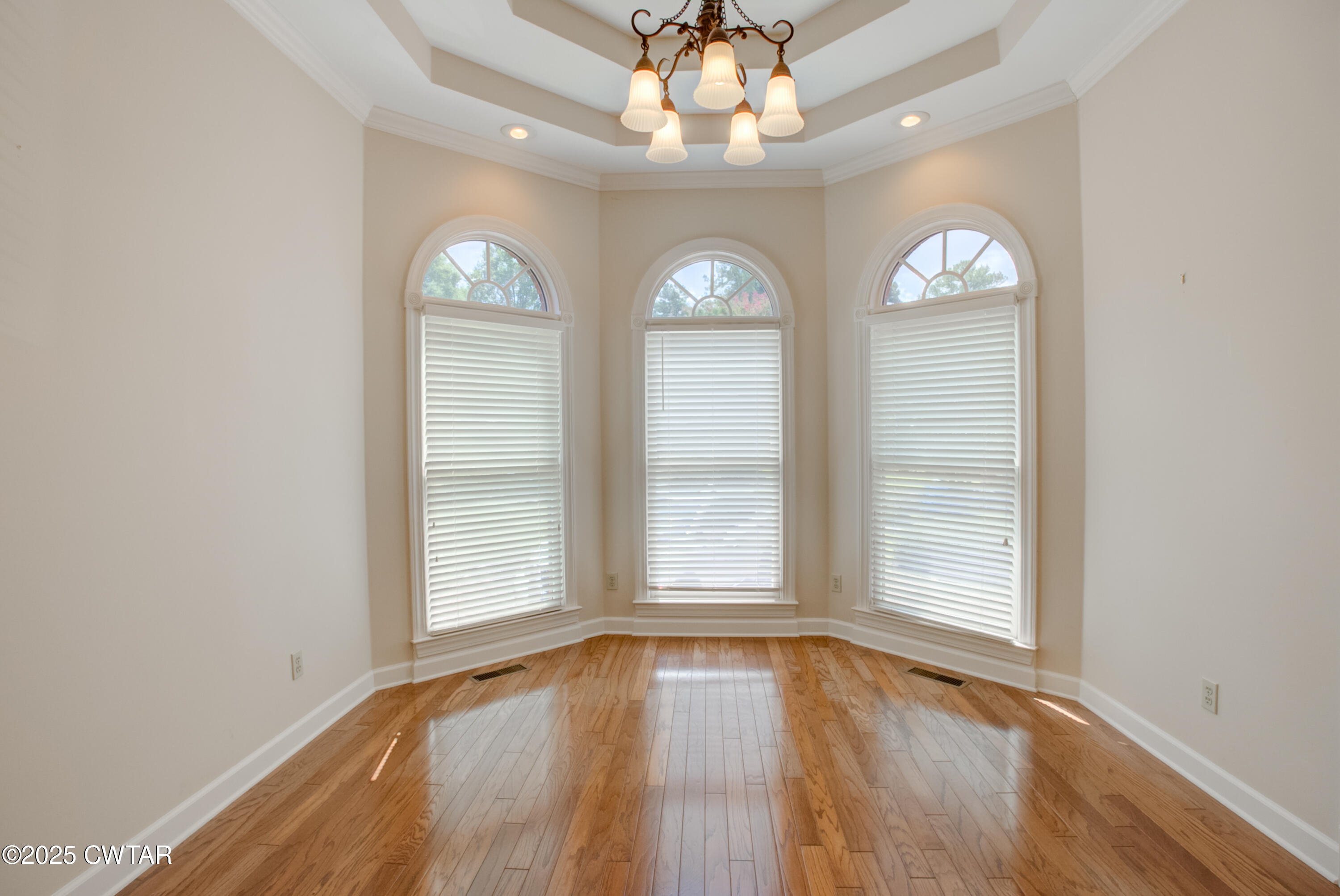 7 Sutton Place Jackson, TN 38305 - Photo 22 of 25 an empty room with wooden floor fan and windows