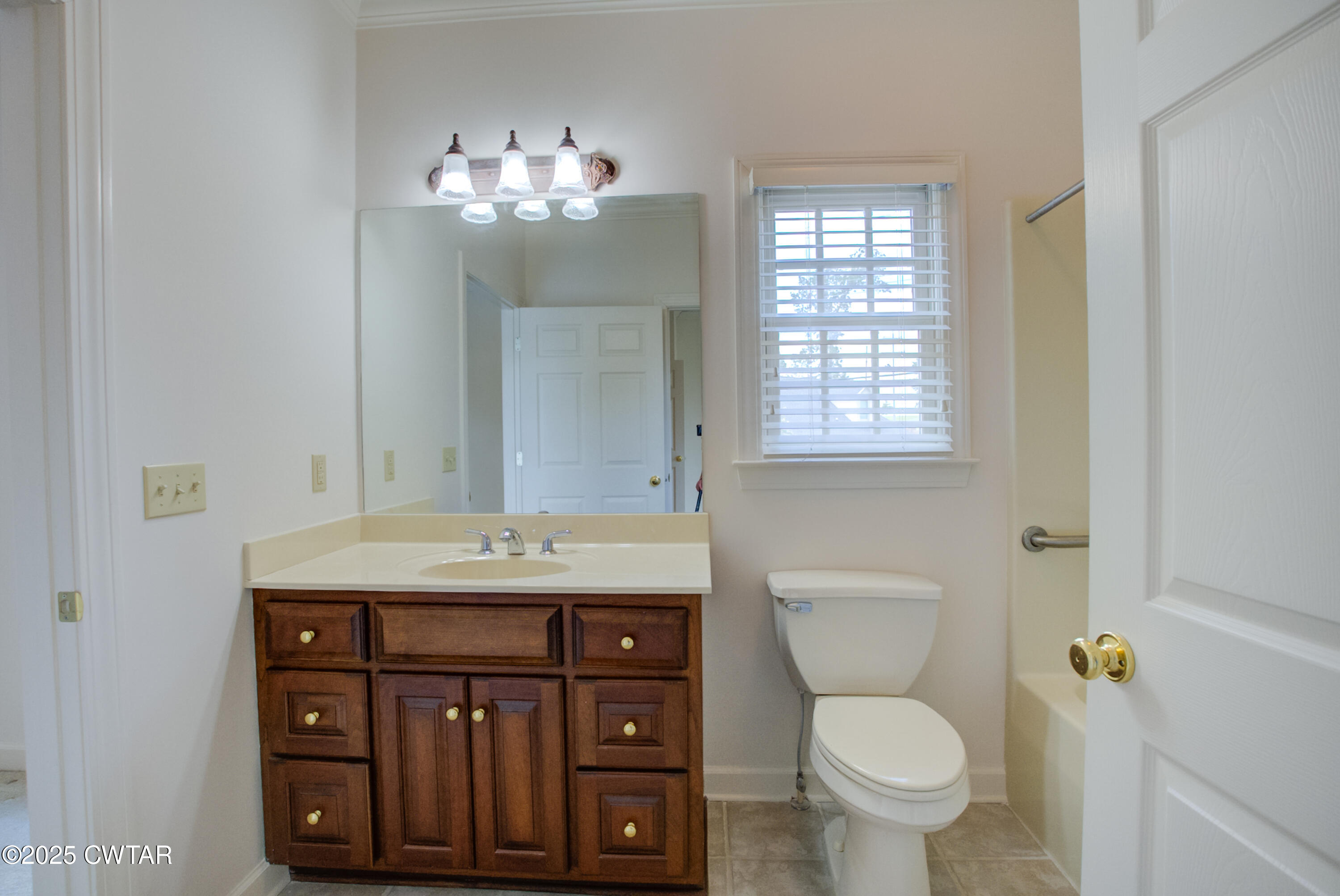 7 Sutton Place Jackson, TN 38305 - Photo 24 of 25 a bathroom with a granite countertop toilet sink and mirror